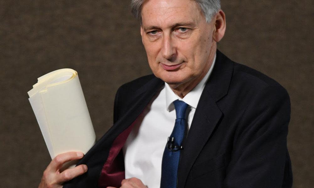 Chancellor Philip Hammond prepares to deliver a speech to trainee bankers in London yesterday. The public spending squeeze is set to tighten soon, with a range of cuts again targeting family benefits.