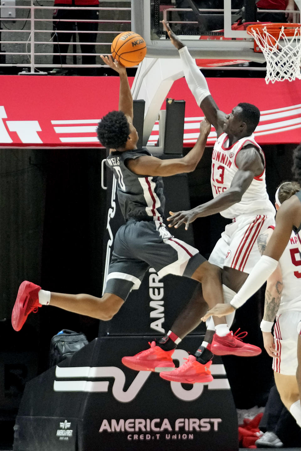 Utah center Keba Keita (13) defends against Washington State forward Jaylen Wells (0) during the second half of an NCAA college basketball game Friday, Dec. 29, 2023, in Salt Lake City. (AP Photo/Rick Bowmer)