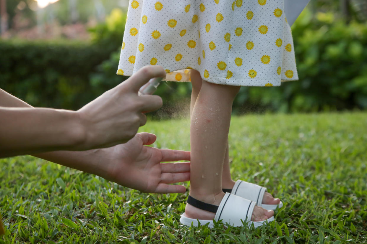 Mother applying mosquito and bugs repellent spray on toddler. PHOTO: Getty Images