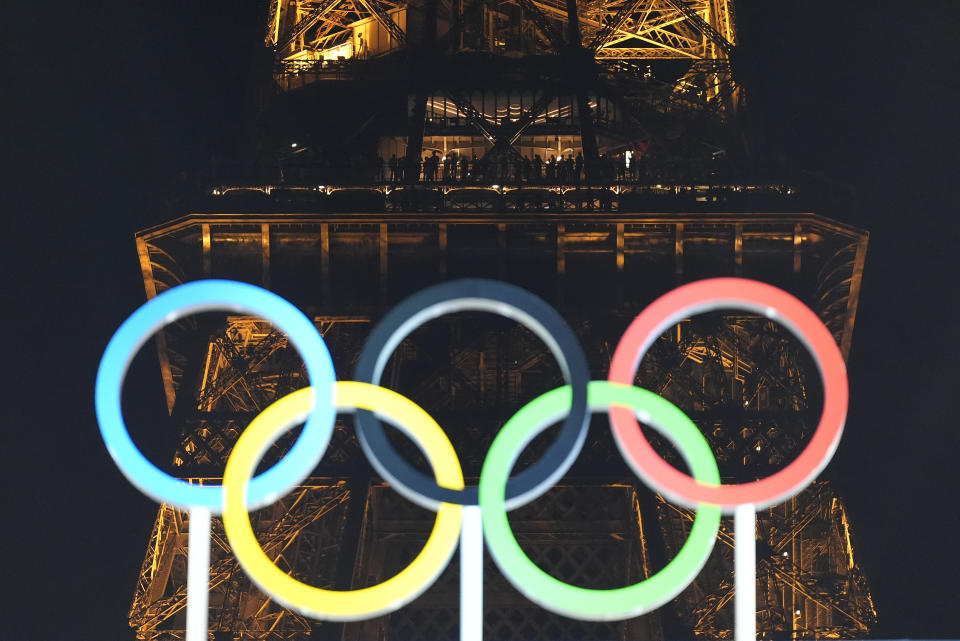 Spectators watch from the second floor of the Eiffel Tower the men's beach volleyball gold medal match between Sweden and Germany at the 2024 Summer Olympics, Saturday, Aug. 10, 2024, in Paris, France. (AP Photo/Robert F. Bukaty)