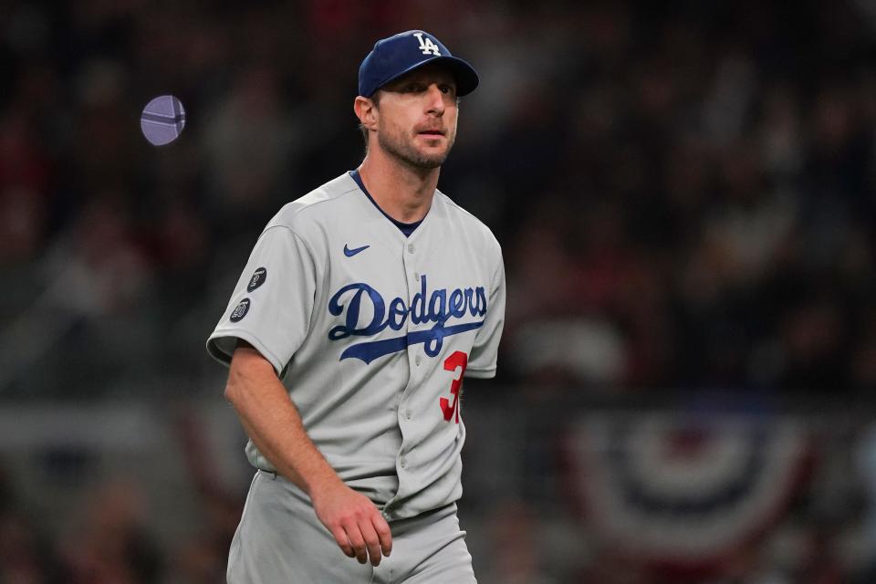 FILE - Los Angeles Dodgers starting pitcher Max Scherzer walks off the field after being relieved in the fifth inning in Game 2 of baseball's National League Championship Series against the Atlanta Braves Sunday, Oct. 17, 2021, in Atlanta. Eight-time All-Star Max Scherzer is nearing a $130 million, three-year contract with the New York Mets, a person familiar with the negotiations told The Associated Press. The person spoke on condition of anonymity Monday, Nov. 29, because the agreement was still being worked on and would be subject to a successful physical.(AP Photo/Brynn Anderson, File)