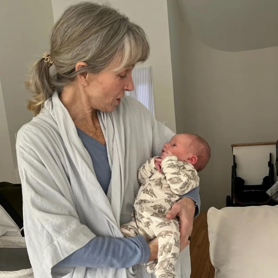 Karen E. Laine holds her grandchild