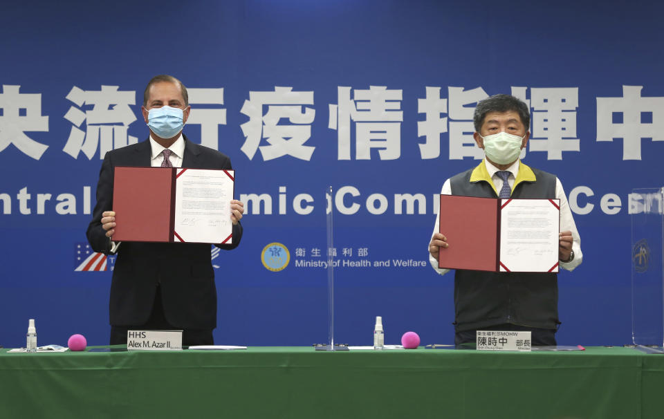 U.S. Health and Human Services Secretary Alex Azar, left, and Taiwanese Minister of Health and Welfare Chen Shih-chung pose for a photo during a signing of a memorandum of understanding at the Central Epidemic Command Center in Taipei, Taiwan, Monday, Aug. 10, 2020. Azar arrived in Taiwan on Sunday in the highest-level visit by an American Cabinet official since the break in formal diplomatic relations between Washington and Taipei in 1979. (AP Photo/Chiang Ying-ying)