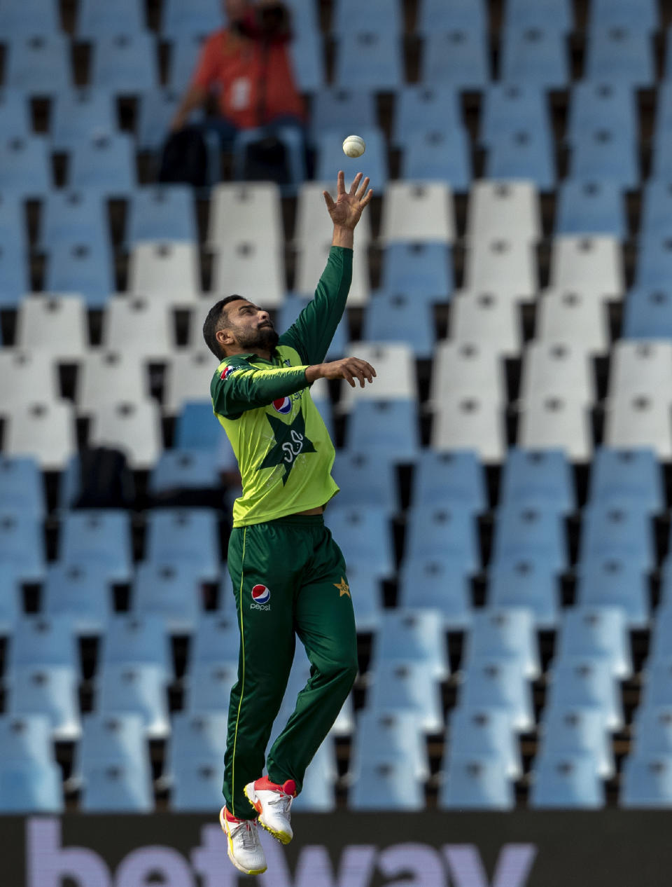 Pakistan's bowler Muhammad Nawaz jumps for the ball during the fourth and final T20 cricket match between South Africa and Pakistan at Centurion Park in Pretoria, South Africa, Friday, April 16, 2021. (AP Photo/Themba Hadebe)