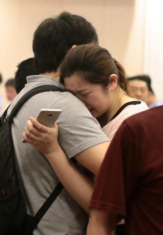 Chinese relatives of passengers on the Dongfangzhixing ferry which sank en route from the eastern city of Nanjing to the southwestern city of Chongqing, react as they wait for information at a hotel in Nanjing, on June 2, 2015