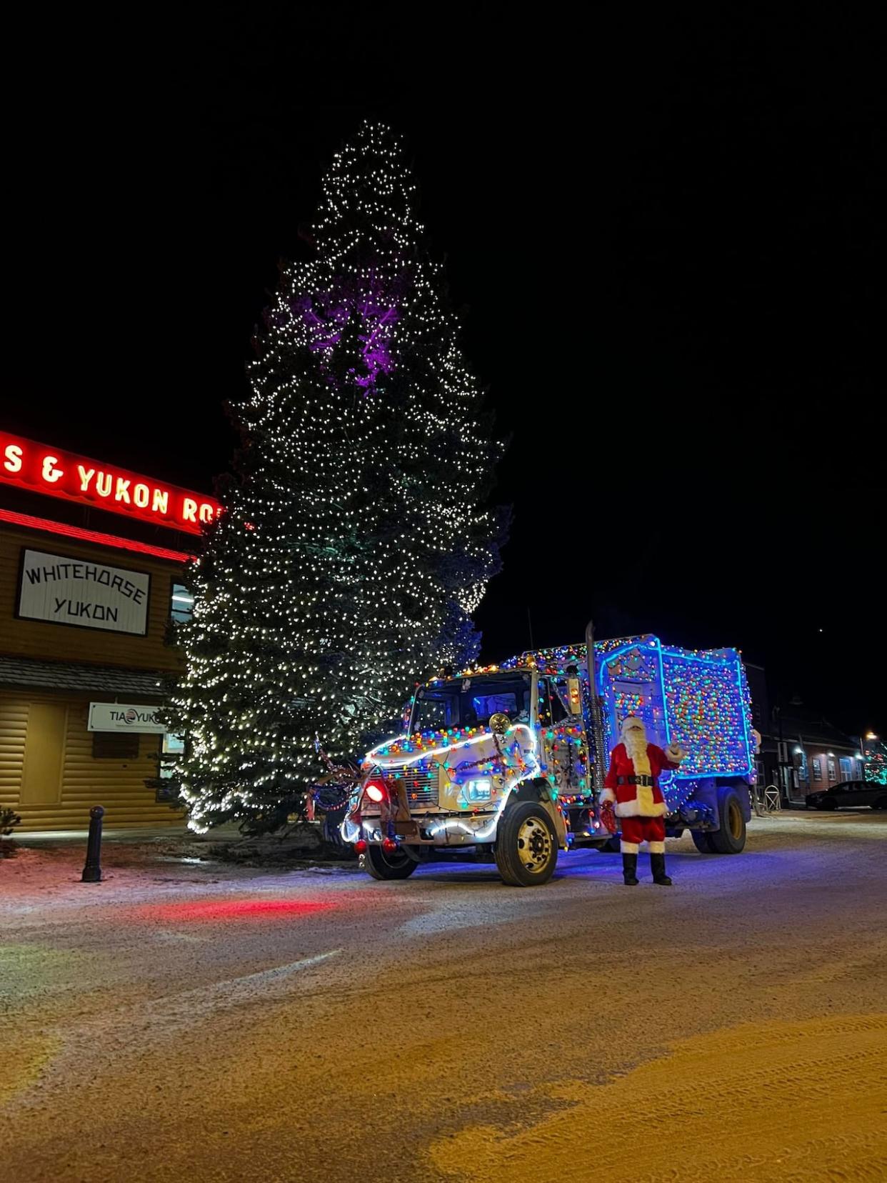 Wayne Henderson, aka Garbage Truck Santa, in downtown Whitehorse. It's been more than 30 years since he started dressing up as Santa and doing his rounds in his festive municipal garbage truck. (Ryan Henderson - image credit)