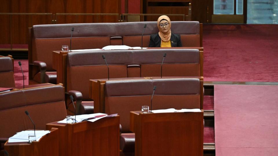 Senator Fatima Payman sitting alone in the chamber