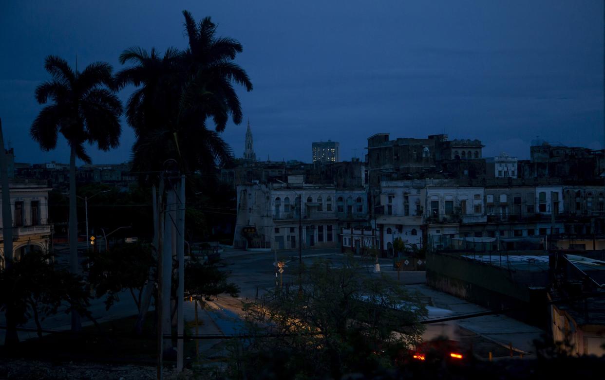 A neighborhood sits dark during a blackout triggered by the passing of Hurricane Ian in Havana, Cuba, early morning Wednesday, Sept. 28, 2022. Hurricane Ian knocked out electricity to the entire island when it hit the island’s western tip as a major storm.