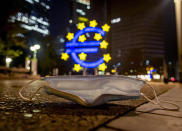 A face mask was left behind near the Euro sculpture in Frankfurt, Germany, early Monday, Oct. 19, 2020. (AP Photo/Michael Probst)