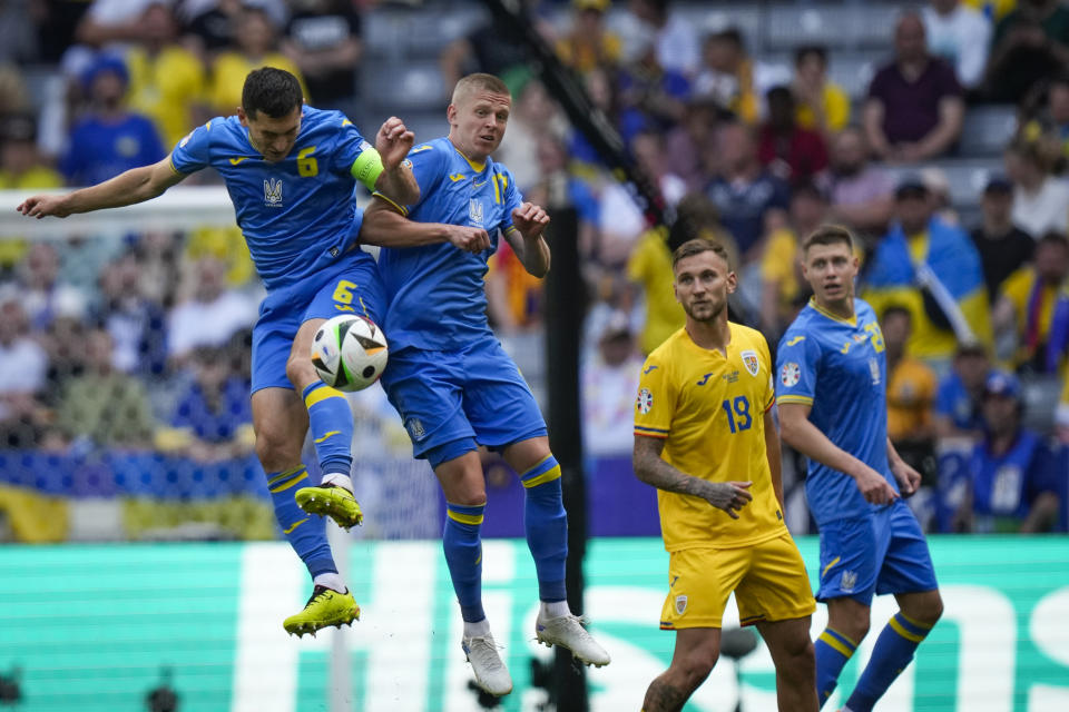 Ukraine's Taras Stepanenko, left, and Ukraine's Oleksandr Zinchenko in action during a Group E match between Romania and Ukraine at the Euro 2024 soccer tournament in Munich, Germany, Monday, June 17, 2024. (AP Photo/Matthias Schrader)