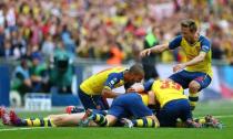 Per Mertesacker celebrates with team mates after scoring the third goal for Arsenal. Reuters / Eddie Keogh