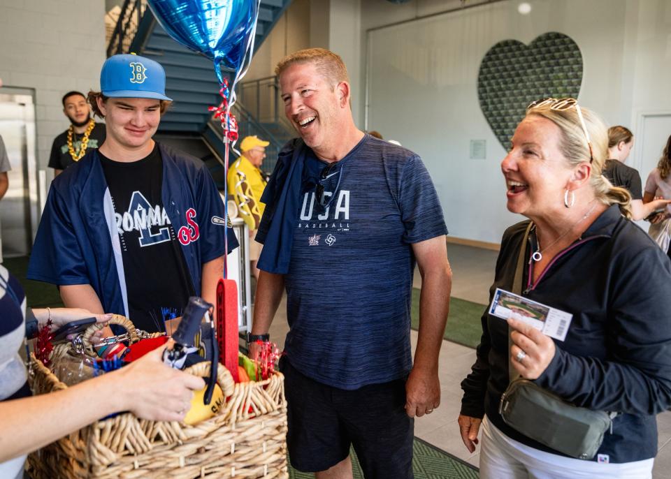 From left to right: Liam Akins, Ken Akins and Noreen Akins are all smiles after learning they purchased the 500,000th ticket to WooSox home games this season. The family from Florida were presented with a premium gift basket and recognized on the field before the second game of a doubleheader at Polar Park.