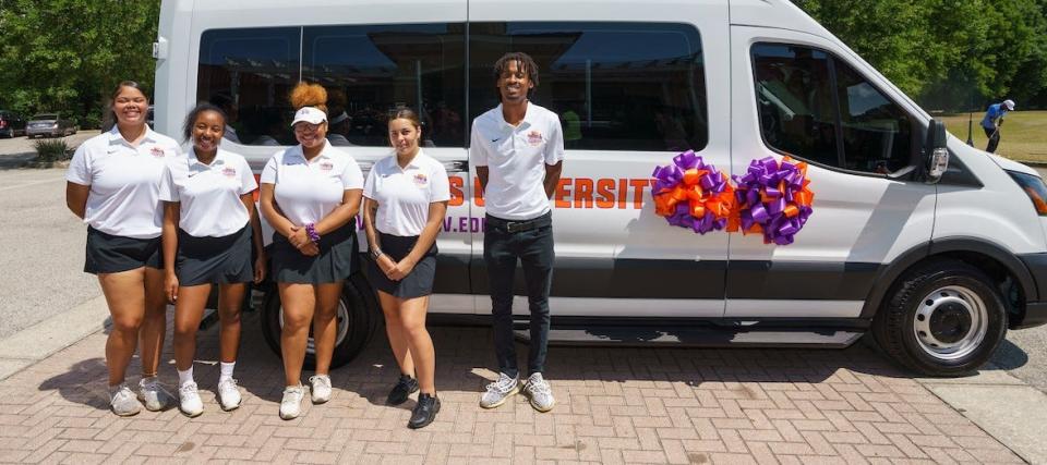 The Edward Waters women’s golf team shows off its new van, which was donated by The Players Championship.