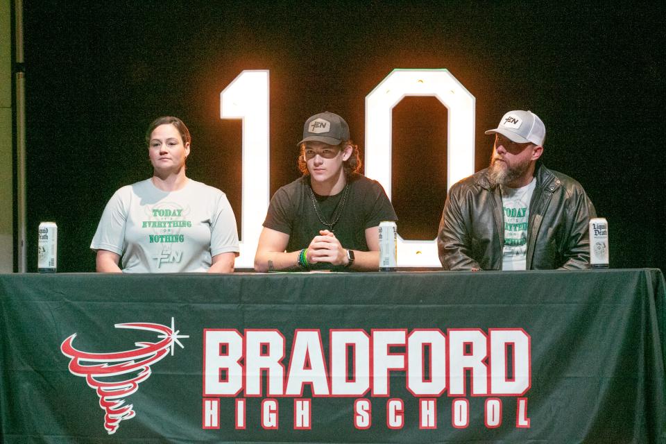 With is mom Samantha Clark, left, and dad Jimmie Clark III right, Bradford High School senior Chason Clark waits for the program to begin so he can sign his letter of intent to play football at Marshall University during a program at Bradford High School in Starke, FL on Wednesday, December 20, 2023. Clark, 6’3 and 210 pounds, was a Middle Linebacker and Tight End on this this years team and went to the state championship. [Alan Youngblood/Gainesville Sun]