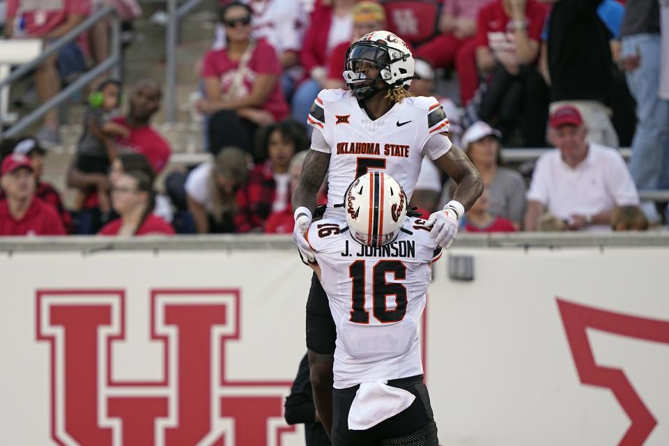Oklahoma State’s Jaden Bray (5) celebrates with Josiah Johnson after a touchdown catch against Houston Saturday, Nov. 18, 2023, in Houston. The Cowboys close out the Big 12 regular season with a home game against BYU on Saturday. | David J. Phillip, Associated Press