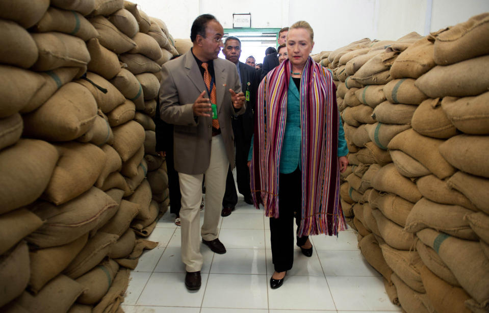 U.S. Secretary of State Hillary Rodham Clinton, right, talks with Agribusiness Advisor Bency Isaac, left, as she tours the Timor Coffee Cooperative in Dili, East Timor Thursday, Sept. 6, 2012. U.S. Secretary of State Hillary Rodham Clinton is in East Timor to offer the small half-island nation support as it ends its reliance on international peacekeepers. (AP Photo/Jim Watson, Pool)