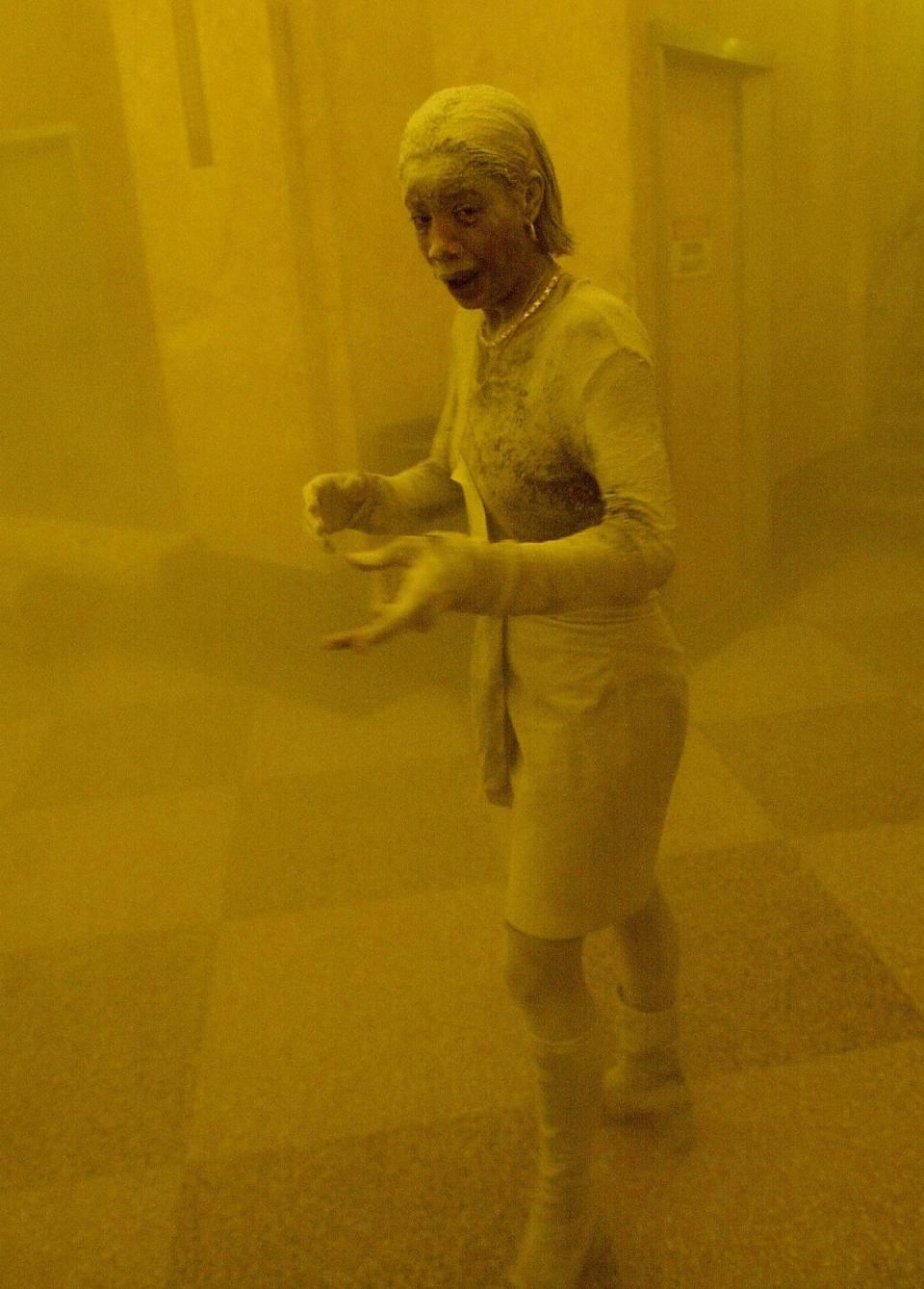 Marcy Borders stands covered in dust as she takes refuge in an office building following the collapse of the Twin Towers (AFP/Getty)