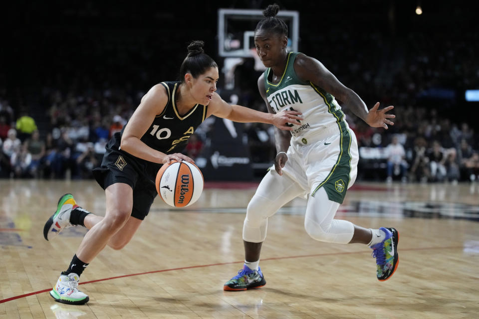 Las Vegas Aces guard Kelsey Plum (10) drives into Seattle Storm guard Jewell Loyd (24) during the first half in Game 2 of a WNBA basketball semifinal playoff series Wednesday, Aug. 31, 2022, in Las Vegas. (AP Photo/John Locher)