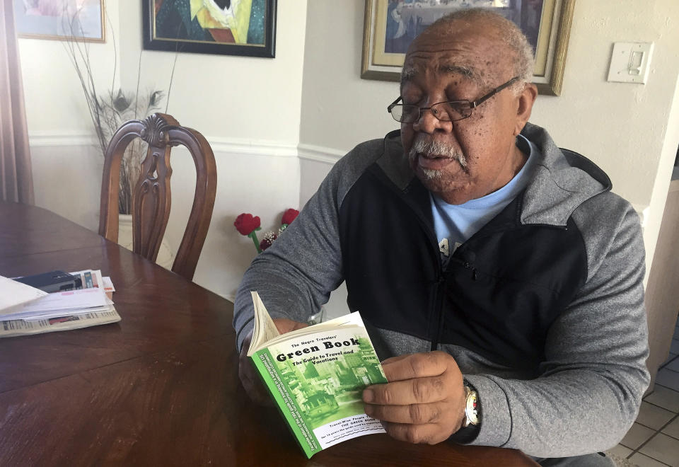 In this Jan. 31, 2019 photo, Charles Becknell, Sr., holds a copy of the 1954 edition of "The Negro Motorist Green Book" at his home in Rio Rancho, N.M. Becknell, of Rio Rancho, New Mexico, grew up in segregated Hobbs and recalls entering some restaurants with his family from the back because only whites could enter from the front. He also attended sit-ins at restaurants where blacks were not allowed at all. “Even our high school football games had segregated seating,” recalled Becknell, who said close friends of differing races would sit on each side of a dividing rope on the bleachers so they could watch a game together. (AP Photo/Russell Contreras)