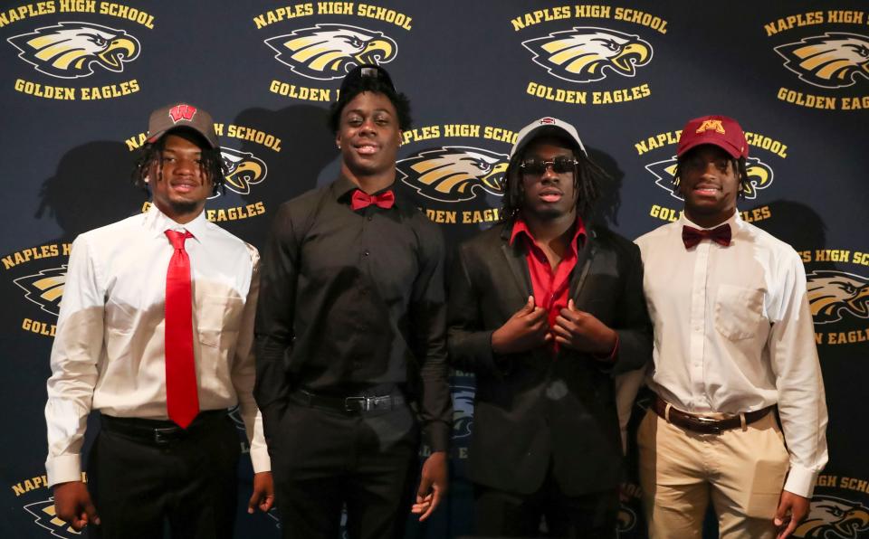 From left: Naples football players Jonas Duclona, Isaiah Augustave, Kerry Brown and Kendrick Raphael pose for a photo during an early signing celebration at Naples High School in Naples on Thursday, Dec. 15, 2022. 