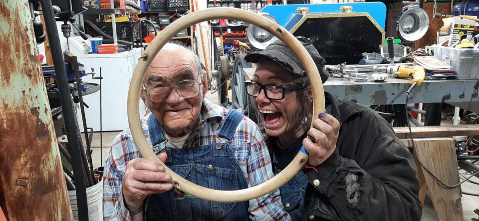 Bob Grimm and his granddaughter, Kirston Hilpert, mug for the camera while working on the steering wheel of the 1907 International Harvester high-wheeler auto buggy. Hilpert's blacksmithing skills were put to use while building the vehicle.