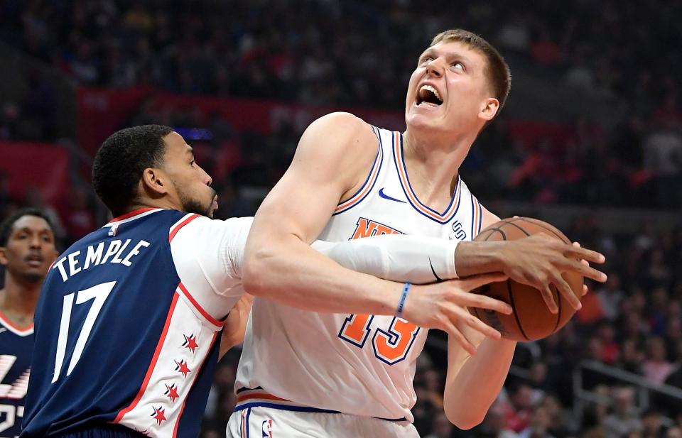 New York Knicks forward Henry Ellenson, right, tries to shoot as Los Angeles Clippers guard Garrett Temple defends.