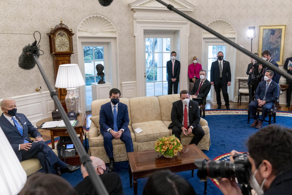 From left, President Joe Biden, Transportation Secretary Pete Buttigieg, House Transportation and Infrastructure Committee Ranking Member Rep. Sam Graves, R-Mo., Rep. Brian Fitzpatrick, R-Pa., Highways and Transit Subcommittee Ranking Member Rep. Rodney Davis, R-Ill., and other members of the House of Representatives meet in the Oval Office of the White House in Washington, Thursday, March 4, 2021, on infrastructure.  (AP Photo/Andrew Harnik)