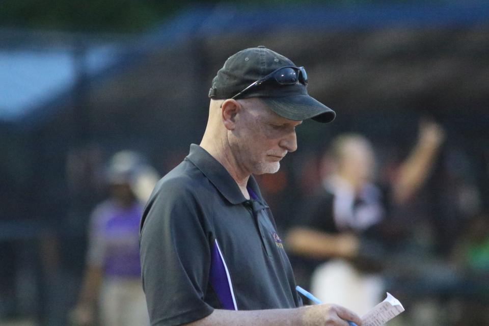 Clarksville softball coach Brian Rush looks over Daniel Boone's lineup while standing by first base between innings of their TSSAA state softball tournament Tuesday, May 24, 2022 at McKnight Park in Murfreesboro.