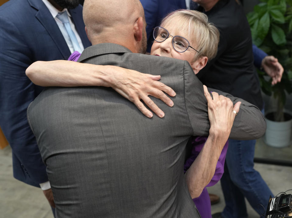 Kathleen Boleyn, right, mother of man who was fatally shot by a police officer from the Arvada, Colo., Police Department in June 2021, hugs attorney Matthew J. Cron after a news conference to talk about the $2.8-million settlement reached with the northwest Denver suburban city Thursday, Sept. 28, 2023, in Denver. Boleyn's son, Johnny Hurley, was shot after he had killed an active shooter who had killed an Arvada officer in the city's Olde Town area on June 21, 2021. (AP Photo/David Zalubowski)