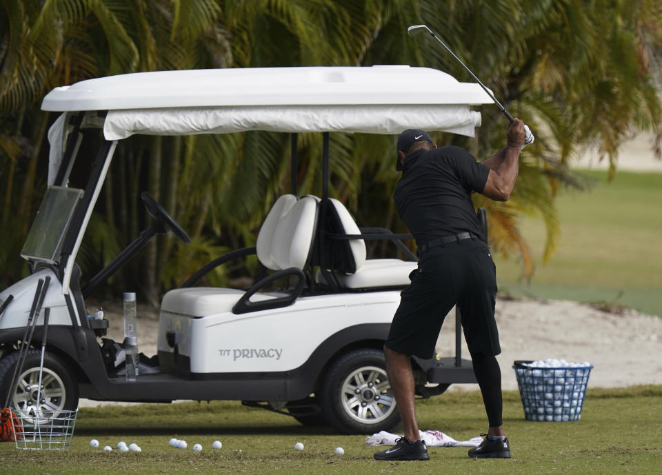 Tiger Woods takes a swing during a practice session at the Albany Golf Club, on the sidelines of day three of the Hero World Challenge Golf tour, in New Providence, Bahamas, Saturday, Dec. 4, 2021. (AP Photo/Fernando Llano)