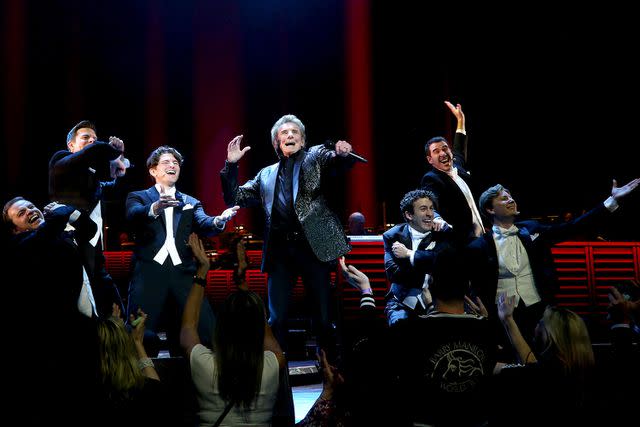 <p>Bruce Glikas/Getty</p> Barry Manilow performing with the cast of 'Harmony' in May 2023