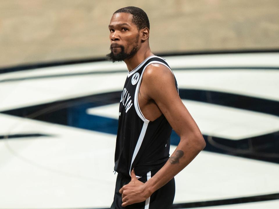 Kevin Durant stands with his hands on his hips during a game in 2021.