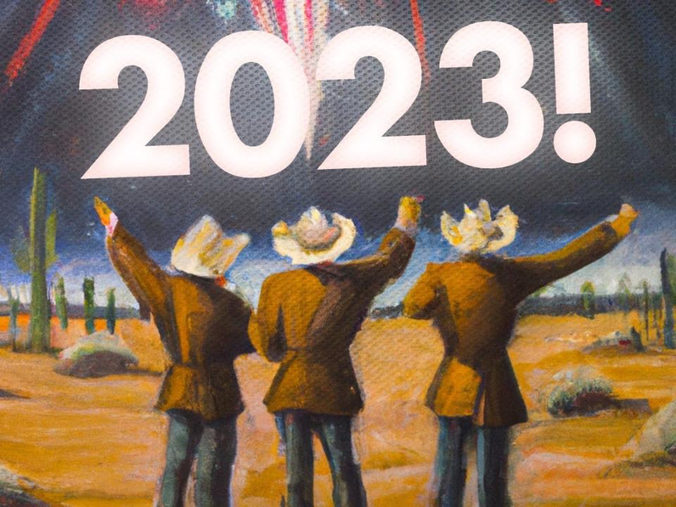 Three people in cowboy clothing with their backs turned watching fireworks in a desert, with the writing "2023!"
