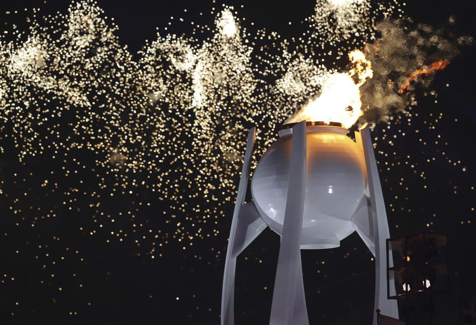 Fireworks explode over the Olympic flame during the opening ceremony of the 2018 Winter Olympics in Pyeongchang, South Korea, Friday, Feb. 9, 2018. (AP Photo/Michael Sohn)