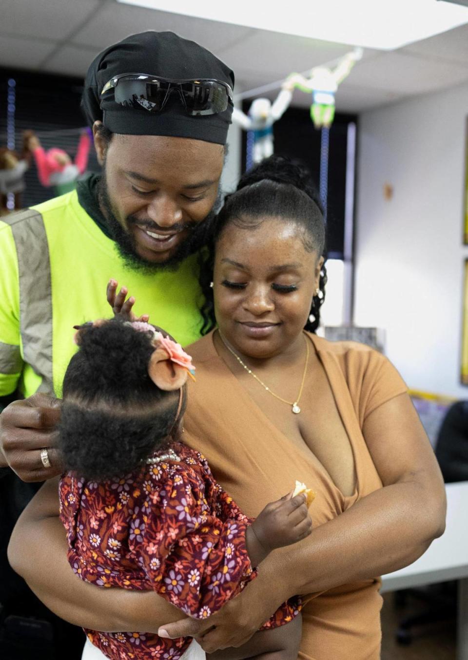 Breon Williams and Darneisha Barnes hold their 10-month-old daughter Da’ Nayvia Barnes at Children of Inmates offices in Northwest Miami-Dade on Nov. 20, 2023.