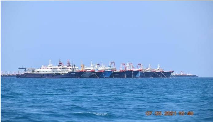 Some of the about 220 vessels reported by the Philippine Coast Guard are pictured at Whitsun Reef, South China Sea