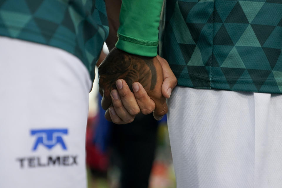 Mexico players hold hands before taking the field for their match against Bulgaria at the Homeless World Cup, Tuesday, July 11, 2023, in Sacramento, Calif. (AP Photo/Godofredo A. Vásquez)