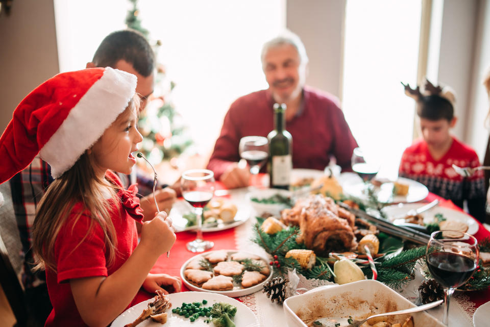 Family with children, grandparents and parents all having Christmas dinner. (Getty Images)