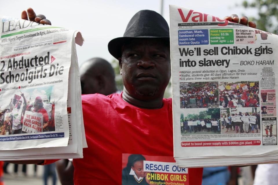 A man display copies of local newspapers during a demonstration calling on the government to rescue kidnapped school girls from Chibok government secondary school, outside the defense headquarters, in Abuja, Nigeria, Tuesday, May 6, 2014. The plight — and the failure of the Nigerian military to find them — has drawn international attention to an escalating Islamic extremist insurrection that has killed more than 1,500 so far this year. Boko Haram, the name means "Western education is sinful," has claimed responsibility for the mass kidnapping and threatened to sell the girls. The claim was made in a video seen Monday. The British and U.S. governments have expressed concern over the fate of the missing students, and protests have erupted in major Nigerian cities and in New York. (AP Photo/ Sunday Alamba)