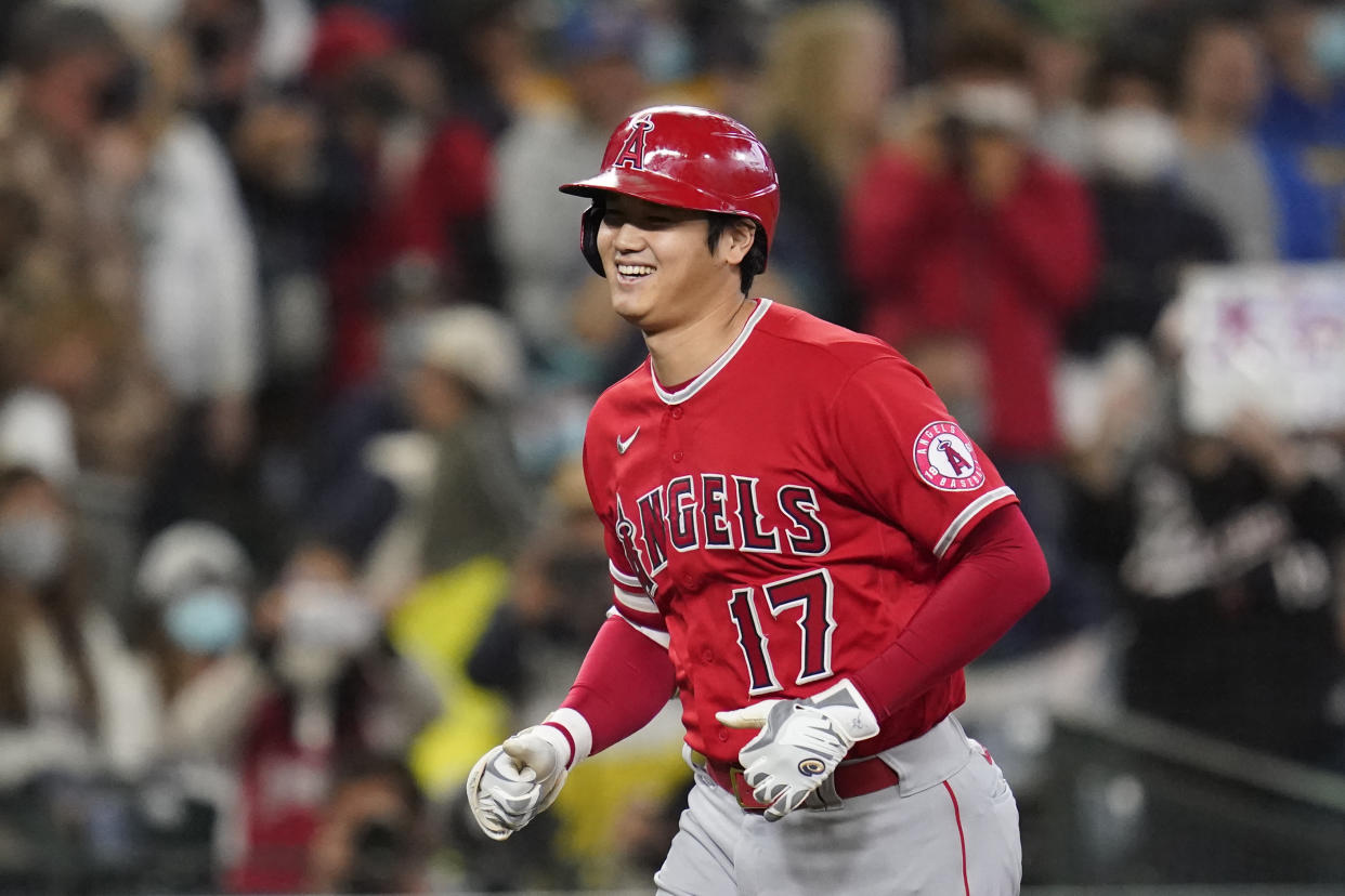 Los Angeles Angels' Shohei Ohtani heads home on his solo home run against the Seattle Mariners in the first inning of a baseball game Sunday, Oct. 3, 2021, in Seattle. (AP Photo/Elaine Thompson)