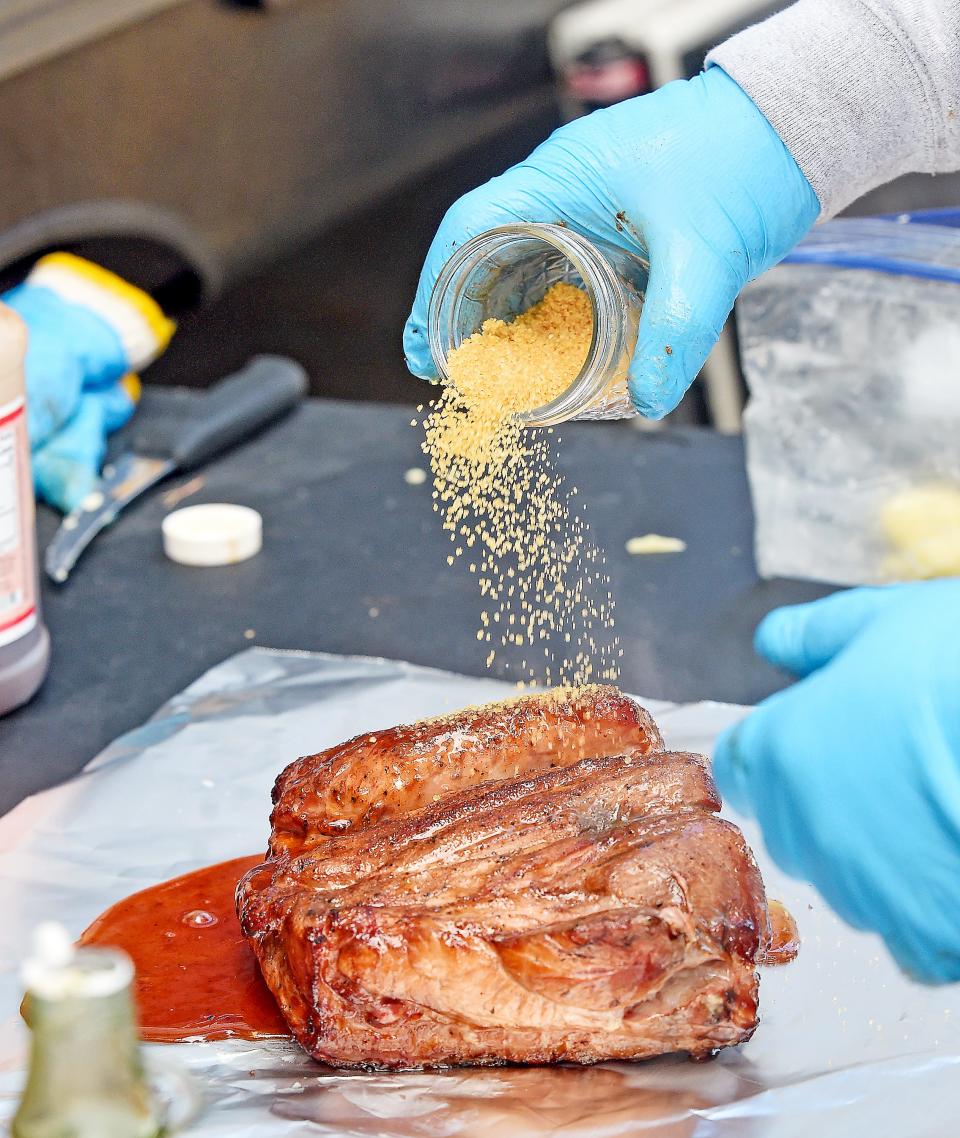 Nathan Harrison seasons and wraps a competition Boston butt on Nov. 13, 2022, during the Kansas City Barbeque Society World Invitational Championship at Noccalula Falls Park in Gadsden. Harrison is part of the Coming in Hot BBQ team from St. Louis.