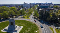 FILE - In this April 7, 2020 file photo sparse traffic winds around the statue of Confederate General Robert E. Lee on Monument Ave near downtown Richmond, Va. If a court clears the way for the state of Virginia to take down one of the country's most prominent Confederate statues, contractors will also be removing something else from the enormous monument: a 134-year-old time capsule rumored to contain a valuable and historically significant photo of deceased President Abraham Lincoln. (AP Photo/Steve Helber)