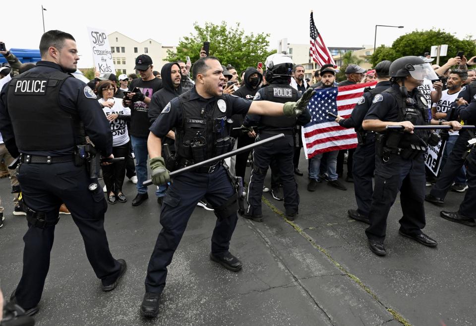 Conservative groups and LGBTQ+ rights supporters protest as police try to maintain order outside the Glendale Unified School District offices in Glendale, California.