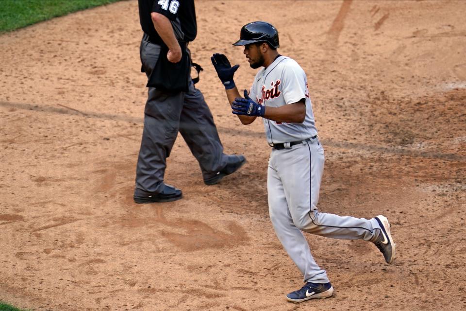 Detroit Tigers' Jeimer Candelario applauds as he scores on a teammate's single by vs. Minnesota Twins in the seventh inning Sunday, Sept. 6, 2020, in Minneapolis.