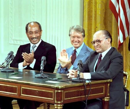 FILE PHOTO: U.S. President Jimmy Carter, Egyptian President Anwar Sadat and Israeli Prime Minister Menachem Begin during the signing of the Camp David Accords in the East Room of the White House