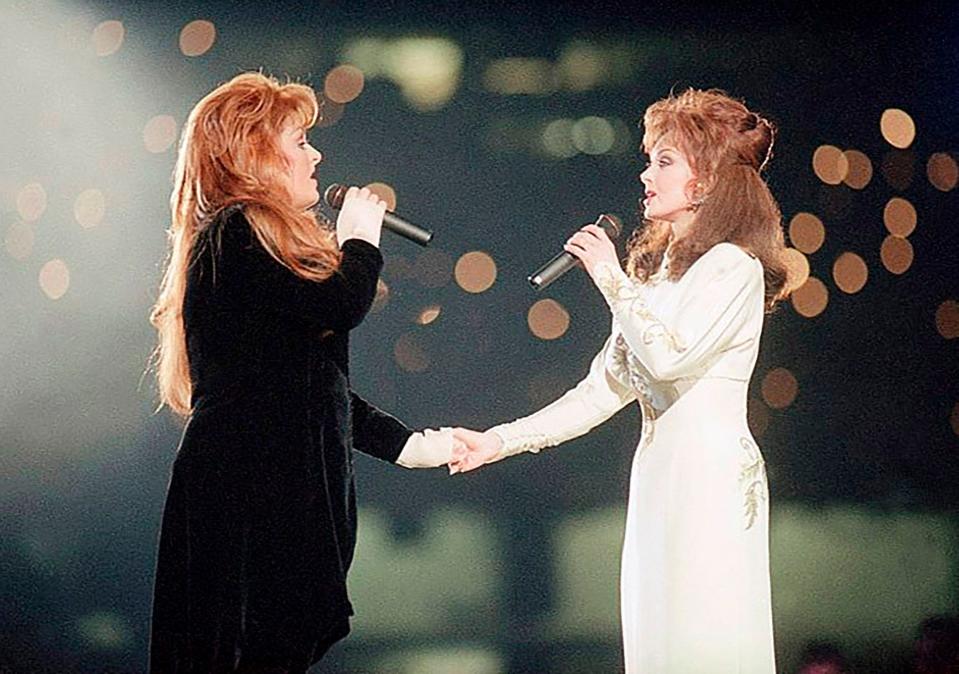 Wynonna Judd, left, and her mother, Naomi, perform during the halftime show at Super Bowl XXVIII in Atlanta on Jan. 30, 1994.