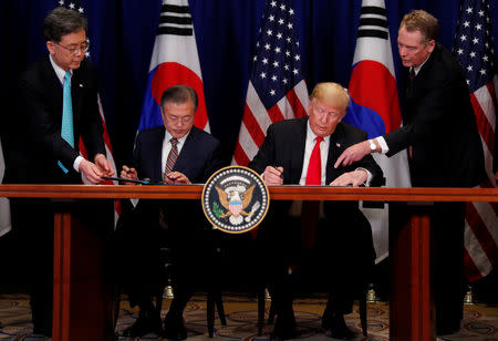 U.S. President Donald Trump and South Korean President Moon Jae-in sign the U.S.-Korea Free Trade Agreementon during a ceremony on the sidelines of the 73rd United Nations General Assembly in New York, U.S., September 24, 2018. REUTERS/Carlos Barria