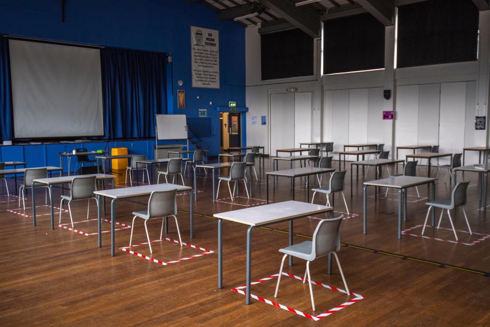 Socially distanced desks are set out for lesson in the hall at a school in Dukinfield, England. (Anthony Devlin via Getty Images)