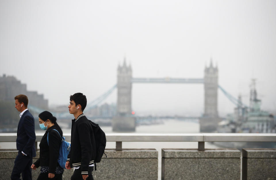 Commuters walk across London Bridge, with the iconic Tower Bridge seen in the background, during the morning rush hour amid an outbreak of the coronavirus disease (COVID-19), in London, September 21, 2020. / Credit: HANNAH MCKAY/REUTERS