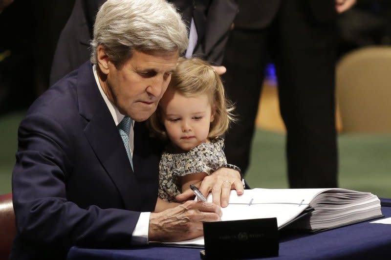 U.S. Secretary of State John Kerry holds his granddaughter Isabelle Dobbs Higginson while he signs the Paris Agreement on climate change at the headquarters of the United Nations in New York City on April 22, 2016. The pact went into effect November 4, 2016. File Photo by John Angelillo/UPI